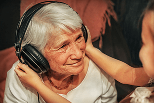 Grandmother listening to music