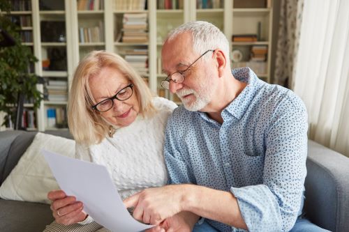 A senior couple reviews their estate plan.