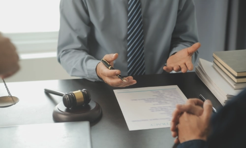 A person consulting with an Alzheimer's and dementia planning lawyer in an office regarding an estate plan.