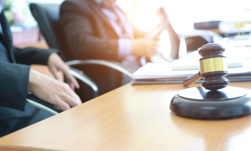 A probate lawyer and his client seated in an office and discussing estate value.