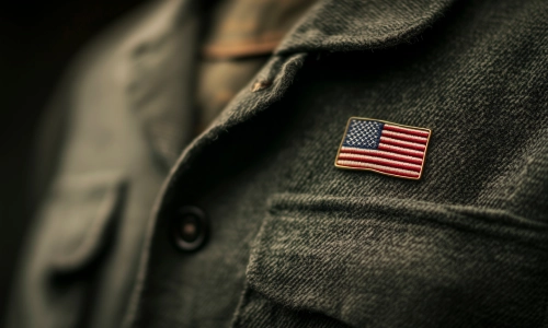 A closeup of a serviceman's uniform with the US flag stitched on.