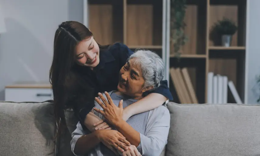 A daughter embracing her aging mother, reflecting elder care planning, fall safety, and dignity.