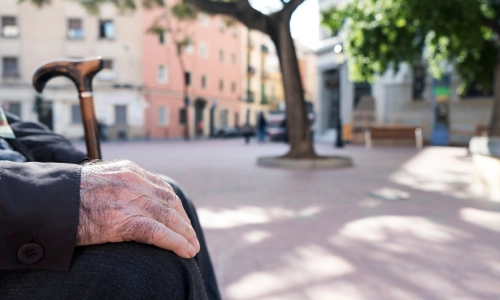 Close up of an elderly Caucasian man sitting on a park bench