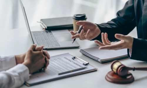 A New Jersey attorney meeting with a client to explain the details of the legal document he prepared.