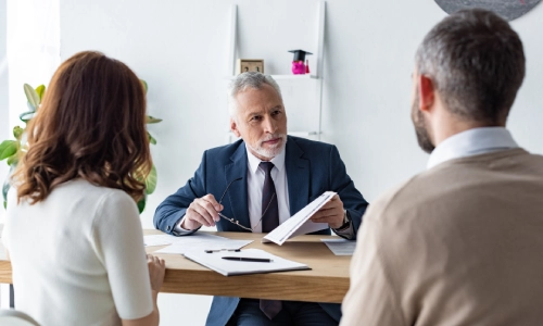 A young couple consulting a New Jersey lawyer about creating a solid estate plan early in life.