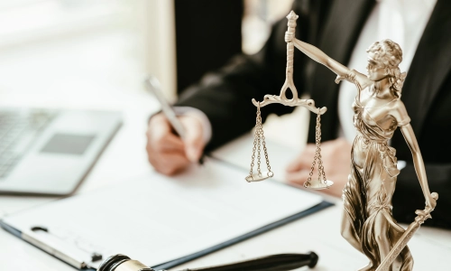 A Hunterdon County trusts and estates lawyer signing a document attached to a clipboard lying on an office desk