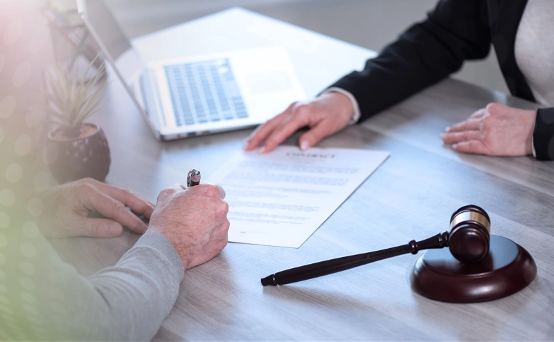 A senior citizen meeting with an estate planning lawyer in her office so they can work together.