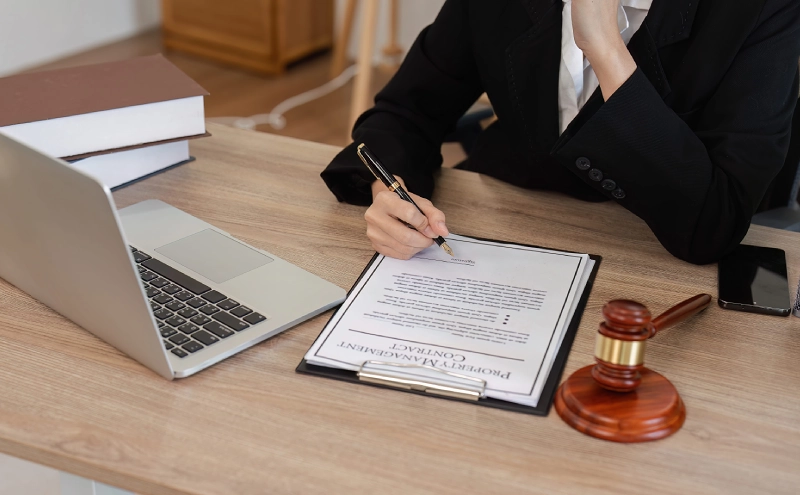 An estate planning attorney reviewing a client's estate plan while seated behind a desk in her office.